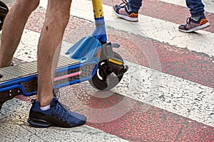 Electric scooter to let the pedestrian on the footpath. City