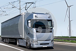 Electric semi truck with pantograph takes energy from wires above the highway