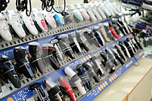 Electric shavers on a shelf in a store. Male and female electric razor