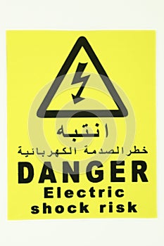 Electric shock risk danger sign board label in blackletter with yellow background