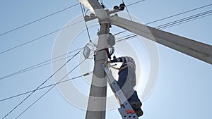 electric silhouette worker engineer working on electric pole standing on stairs