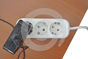 Electric socket cable on a wooden table