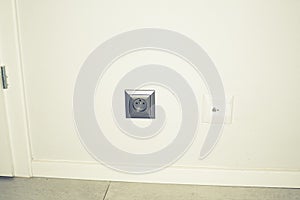 Electric socket closeup in wall