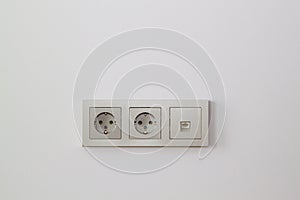 electric sockets and Internet socket in champagne color on the wall