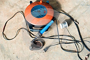 A Electric soldering iron blue handle and Roll of soldering wire w