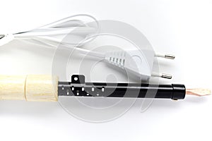 Electric soldering iron with a wooden handle on a white background. A tool for soldering radio components