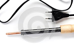 Electric soldering iron with a wooden handle on a white background. A tool for soldering radio components