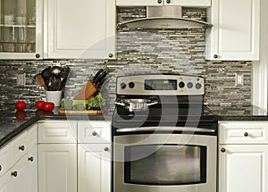 Electric Stainless steel stove, kitchen utensils and vegetables