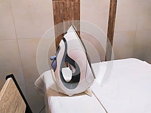 Electric steam iron on the table