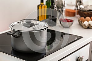 Electric stove with stewpan in kitchen