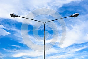 Electric street light pole on blue vivid sky in day light.