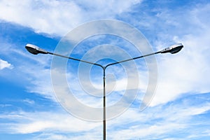 Electric street light pole on blue vivid sky in day light.