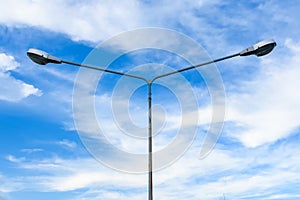 Electric street light pole on blue vivid sky in day light.