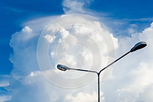 Electric street light pole on blue vivid sky in day light.