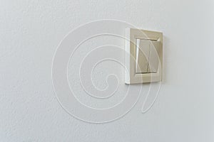 Electric switch on a white wall