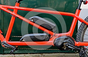 Electric tandem bicycle. Details of the double battery on the chassis and engine .
