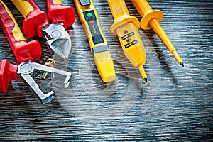 Electric tester nippers insulated strippers on wooden board