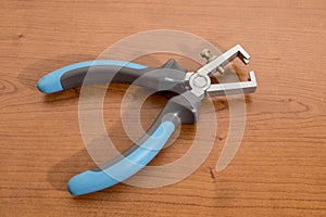 Electric tool, blue wire stripper on a wood table