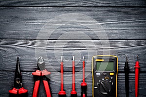 Electric tools on black wooden backdrop