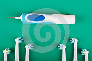 Electric toothbrush on a green background.
