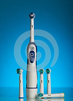 Electric toothbrush and replaceable nozzles of different colors