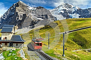 Electric tourist train and Eiger North face,Bernese Oberland,Switzerland photo