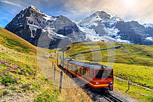 Electric tourist train and Eiger North face,Bernese Oberland,Switzerland photo