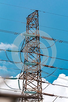 Electric tower or transmission or electricity hydro or pylon with blue Sky and clouds on background