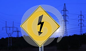 Electric towers at night with electricity label