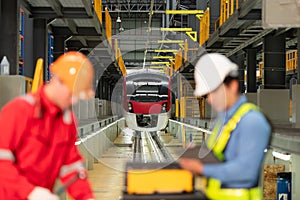 Electric train engineer and technician using repair tools of the electric train industry