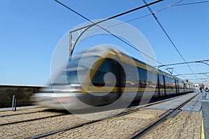 Electric train moving blurred near the station