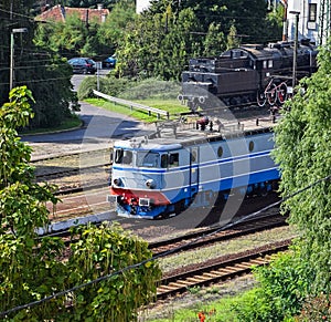 Electric train and an old locomotive