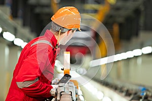 After the electric train is parked in the electric train repair shop, an electric train technician with tools inspect the railway