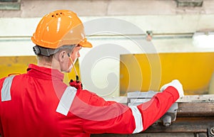 After the electric train is parked in the electric train repair shop, an electric train technician with tools inspect the railway