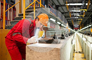 After the electric train is parked in the electric train repair shop, an electric train technician with tools inspect the railway