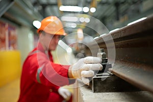 After the electric train is parked in the electric train repair shop, an electric train technician with tools inspect the railway