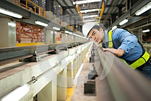 After the electric train is parked in the electric train repair shop, an electric train technician with tools inspect the railway