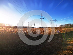 Electric transmission line. Power transmission pylon silhouette against blue sky at dusk. The concept of electrification