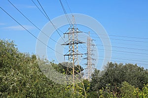 Electric transmission lines in the city. High voltage transmission towers. Power transmission pylons. Heating season
