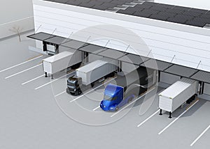 Electric trucks parking in front of modern logistics center. Solar panels mounted on the roof