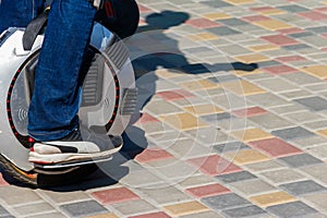 Electric unicycle. Man rides on mono wheel in park