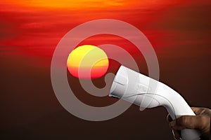 Electric vehicle charger plug on the sunse  background, Concept of renewable energy and pure energy