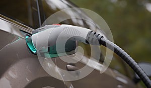 Electric vehicle is charging the battery with power supply. EV fuel Plug in hybrid car. 3D rendered illustration.
