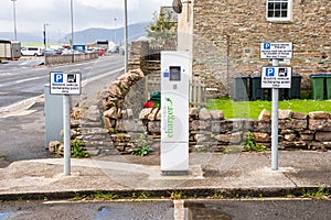 Electric vehicle charging station along a street in a coastal town in Scotland