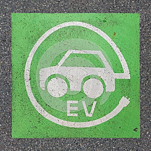 Electric vehicle charging station sign paint on asphalt