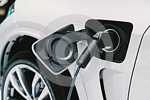 Electric Vehicle charging system. EV fuel for advanced hybrid car. Modern automobile technology or advanced energy concept photo