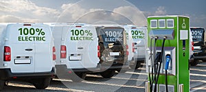 Electric vehicles charging station on a background of a row of vans