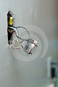 Electric wall outlet coming out of wall
