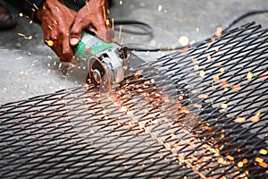 Electric wheel grinding on steel structure on sieve.