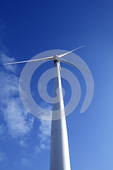Electric wind mill viewed over blue sky